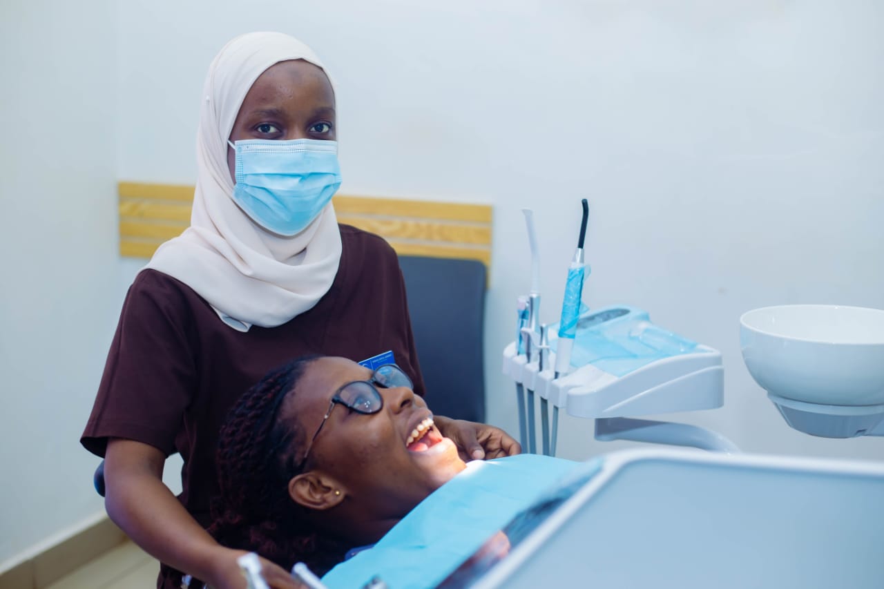 A patient smiling during treatment at Rubaga Dental Surgery