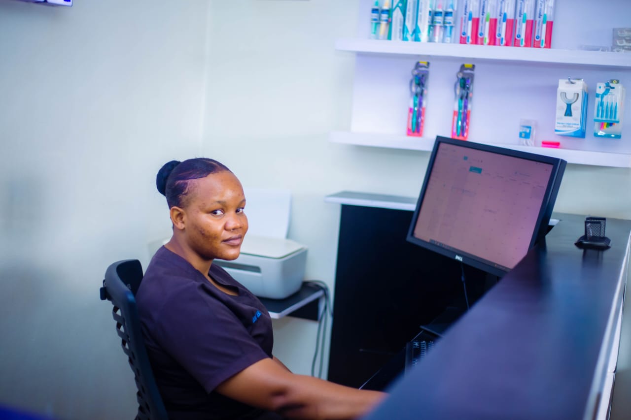 A Rubaga Dental Surgery team member at the reception desk